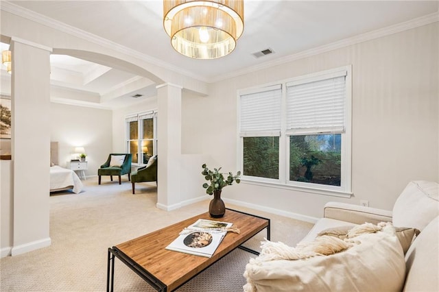 living room with carpet flooring, ornate columns, and crown molding