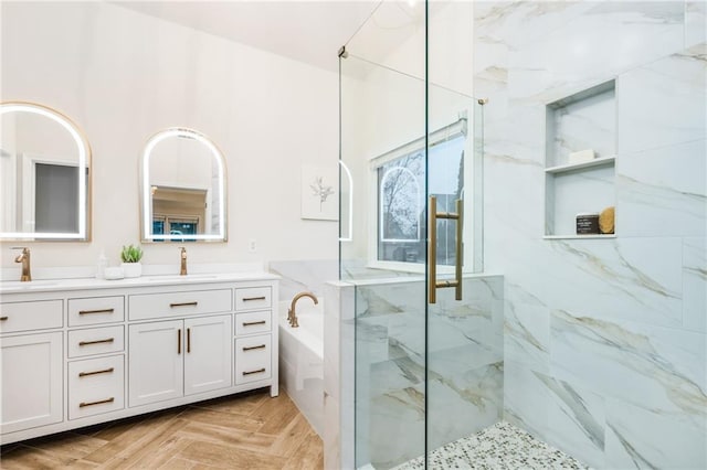 bathroom featuring vanity, parquet floors, and separate shower and tub