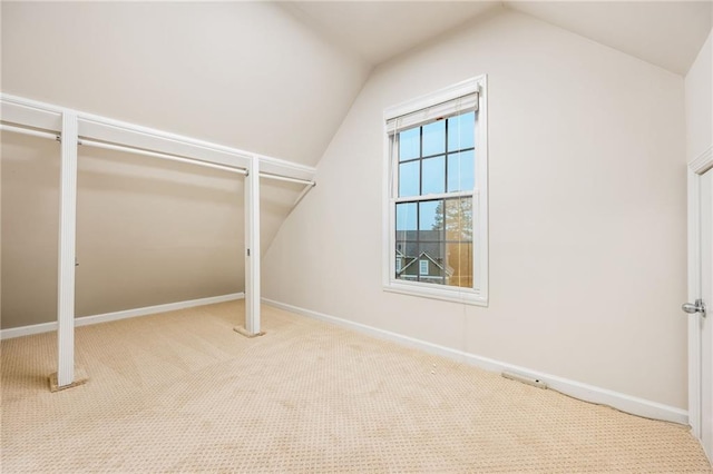 walk in closet featuring lofted ceiling and carpet flooring