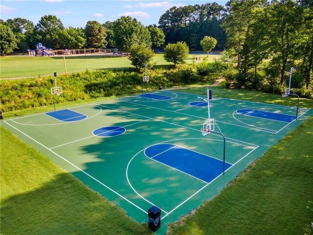 view of basketball court featuring a yard and a playground