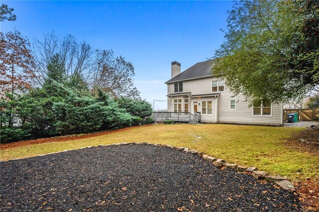 exterior space featuring a deck and a lawn