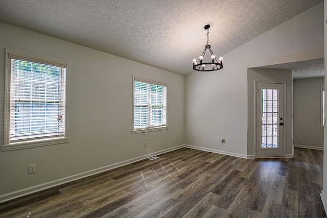 515 Allens Landing Ct, Lawrenceville, GA 30045 - spare room featuring dark wood-style flooring, a chandelier, a textured ceiling, vaulted ceiling, and baseboards