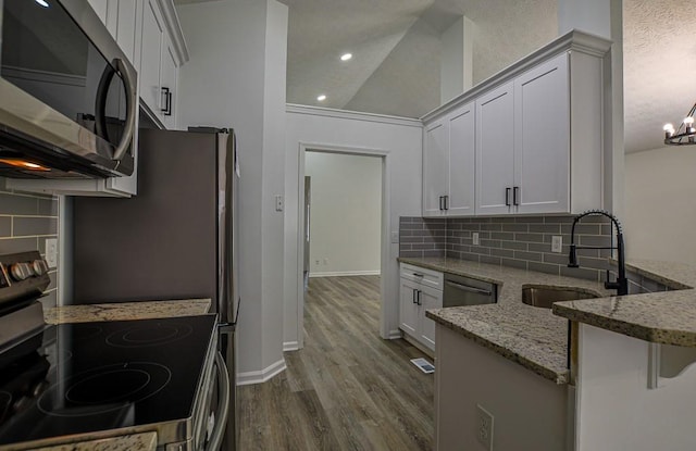 515 Allens Landing Ct, Lawrenceville, GA 30045 - kitchen featuring stainless steel appliances, a sink, light stone counters, decorative backsplash, and dark wood finished floors