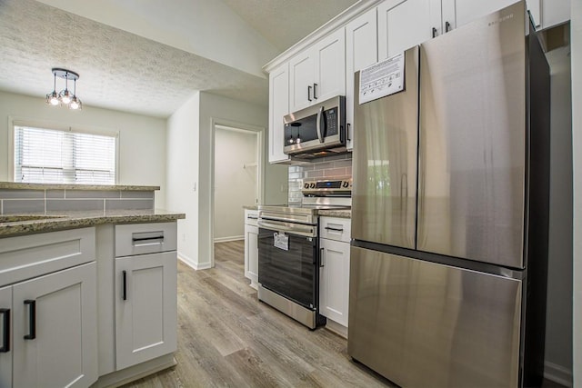 515 Allens Landing Ct, Lawrenceville, GA 30045 - kitchen featuring stainless steel appliances, a textured ceiling, tasteful backsplash, white cabinetry, and baseboards