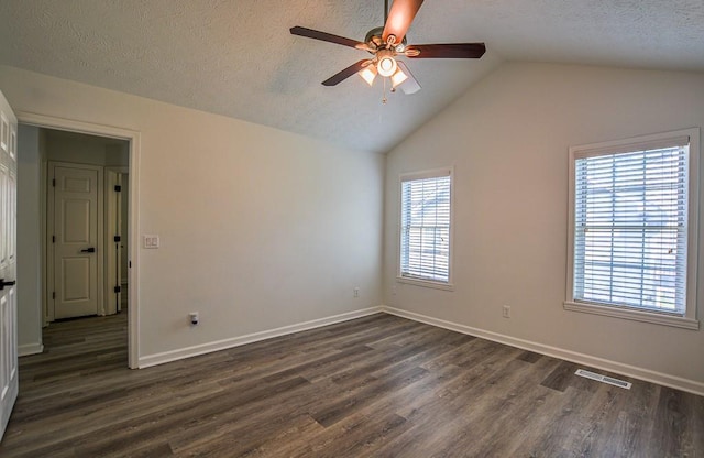 515 Allens Landing Ct, Lawrenceville, GA 30045 - empty room with ceiling fan, dark wood finished floors, vaulted ceiling, baseboards, and a textured ceiling