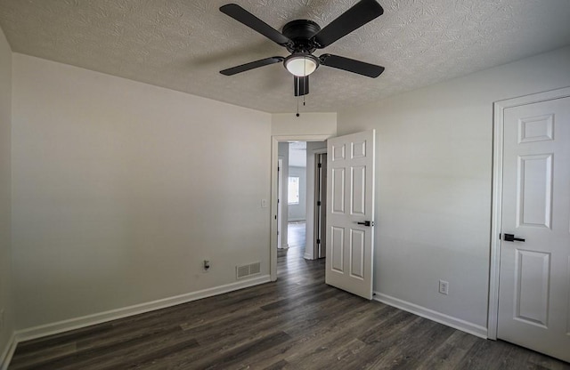 515 Allens Landing Ct, Lawrenceville, GA 30045 - unfurnished bedroom with dark wood-type flooring, a textured ceiling, baseboards, and a ceiling fan