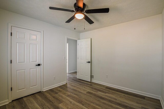 515 Allens Landing Ct, Lawrenceville, GA 30045 - unfurnished bedroom with dark wood-style flooring, baseboards, a textured ceiling, and ceiling fan