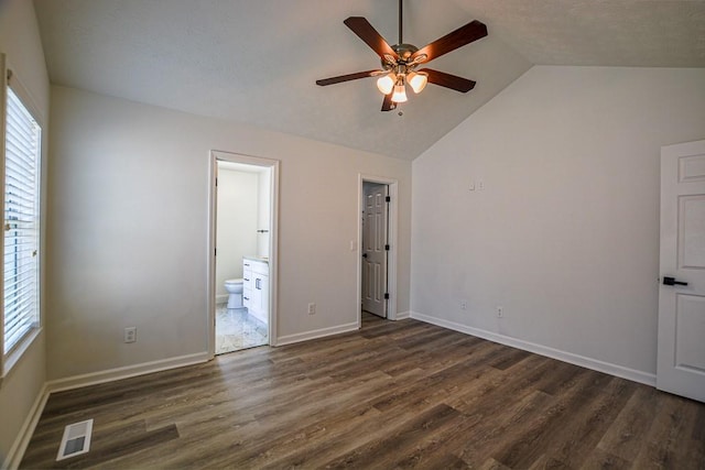 515 Allens Landing Ct, Lawrenceville, GA 30045 - unfurnished bedroom with vaulted ceiling, multiple windows, dark wood-style flooring, ensuite bathroom, and baseboards