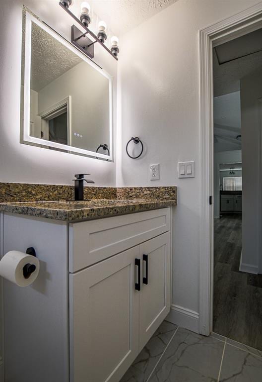 515 Allens Landing Ct, Lawrenceville, GA 30045 - bathroom with vanity, baseboards, and marble look tiles