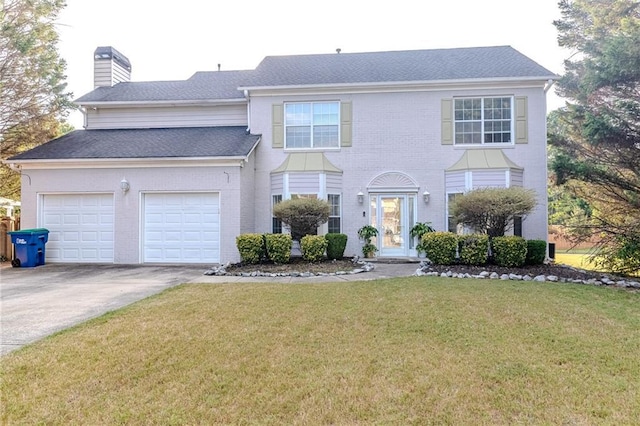 front of property with a garage and a front yard