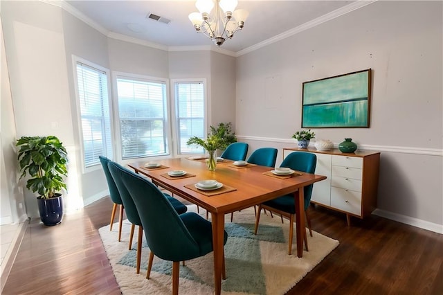 dining space featuring a notable chandelier, ornamental molding, and dark hardwood / wood-style floors