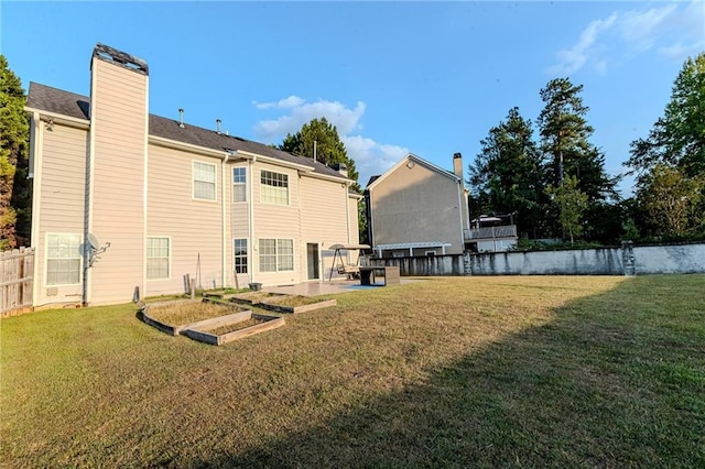 rear view of property with a yard