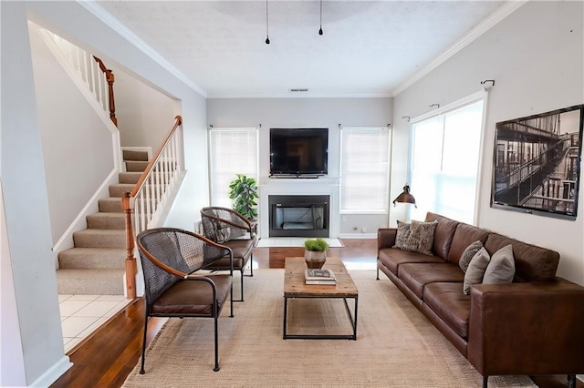 living room featuring ornamental molding and light hardwood / wood-style floors