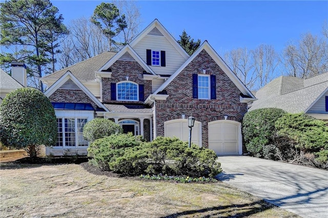 view of front of property featuring brick siding, driveway, an attached garage, and roof with shingles