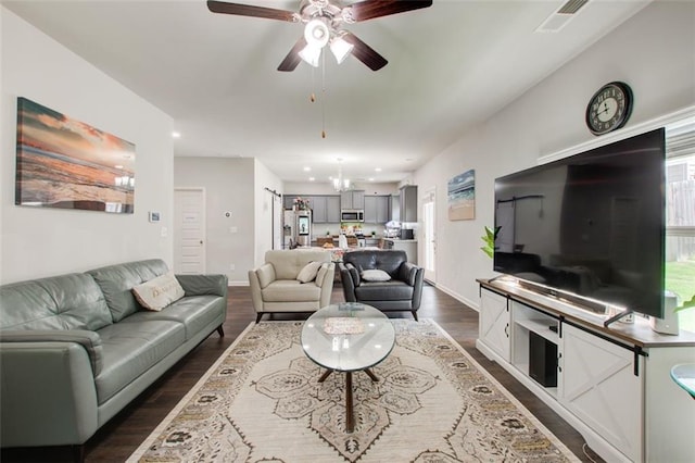 living area featuring dark wood-style floors, recessed lighting, visible vents, baseboards, and ceiling fan with notable chandelier