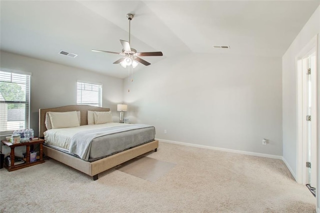 bedroom featuring carpet floors, baseboards, visible vents, and vaulted ceiling