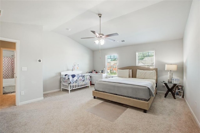 carpeted bedroom with vaulted ceiling, ceiling fan, visible vents, and baseboards