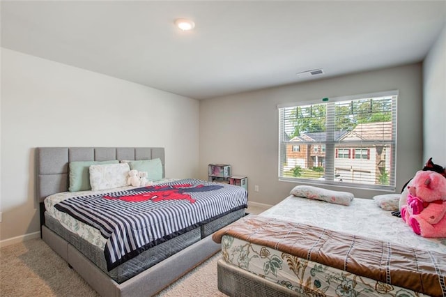 carpeted bedroom featuring visible vents and baseboards