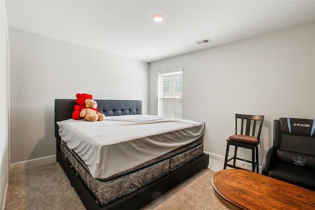 bedroom featuring carpet flooring, visible vents, and baseboards