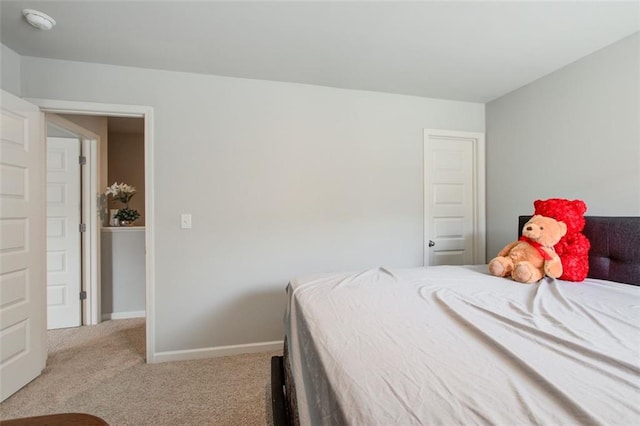 bedroom featuring carpet flooring and baseboards