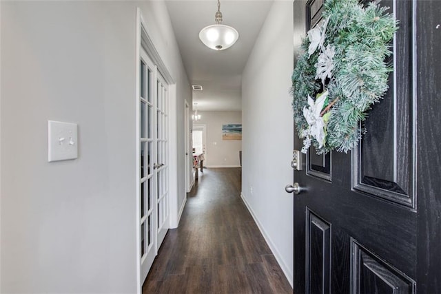 hall with dark wood finished floors and baseboards