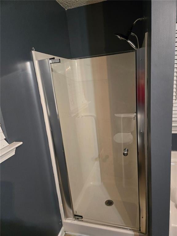 bathroom with a shower with door