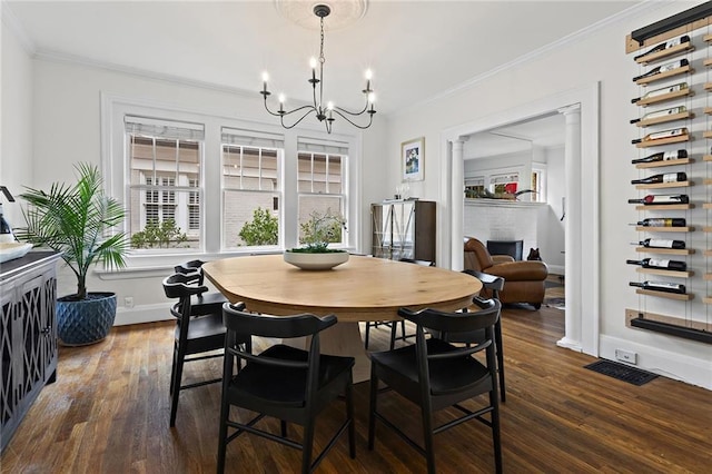 dining area featuring an inviting chandelier, baseboards, ornamental molding, and dark wood finished floors