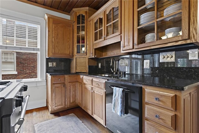 kitchen featuring black dishwasher, decorative backsplash, dark wood-style floors, stainless steel stove, and a sink