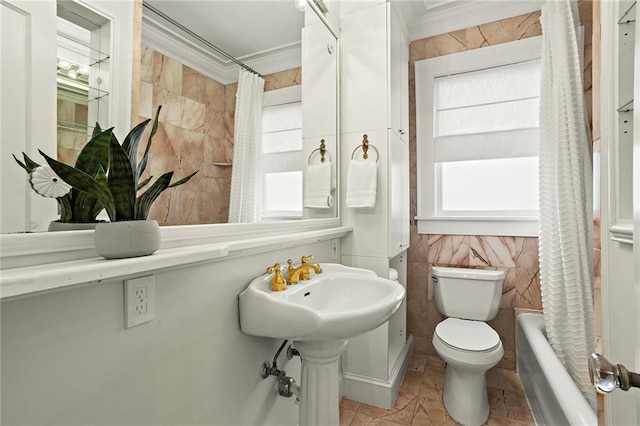 bathroom featuring crown molding, tile walls, and toilet