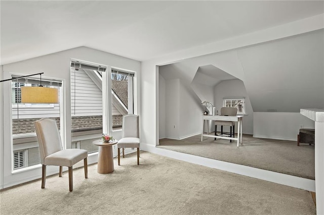 living area featuring carpet floors, vaulted ceiling, and baseboards