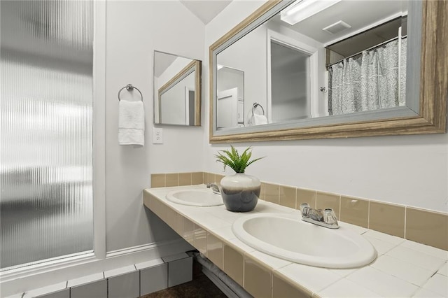 full bathroom featuring double vanity, a sink, and visible vents