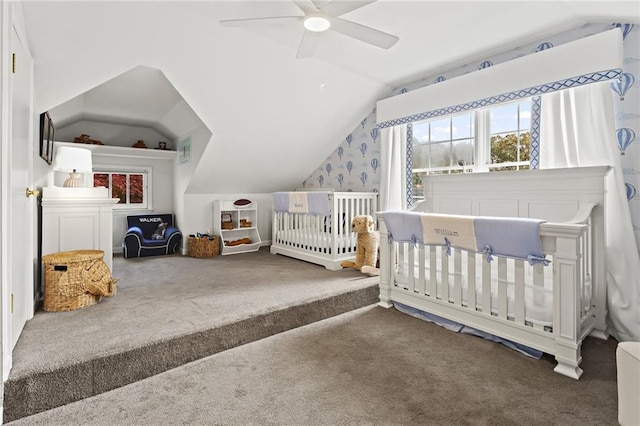 bedroom with lofted ceiling, carpet floors, a crib, and a ceiling fan