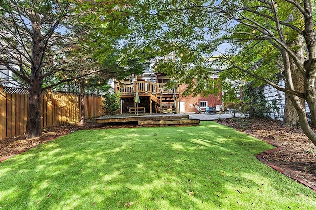 view of yard featuring a fenced backyard, stairs, a patio, and a wooden deck