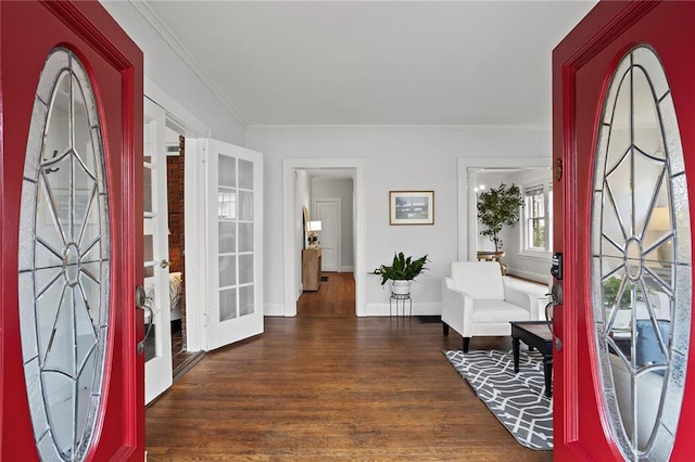 entryway with ornamental molding, french doors, baseboards, and wood finished floors