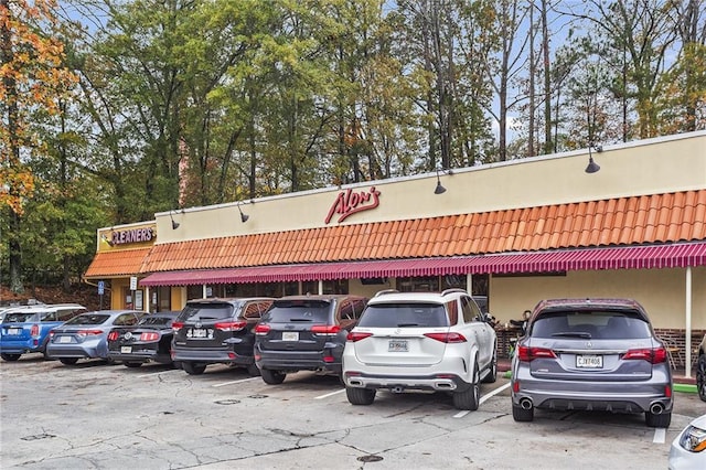 view of building exterior featuring uncovered parking