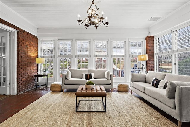 sunroom / solarium with visible vents and a chandelier