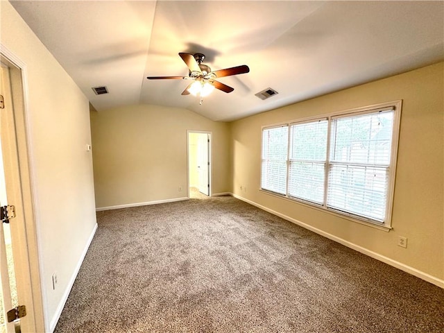 carpeted empty room featuring ceiling fan and vaulted ceiling