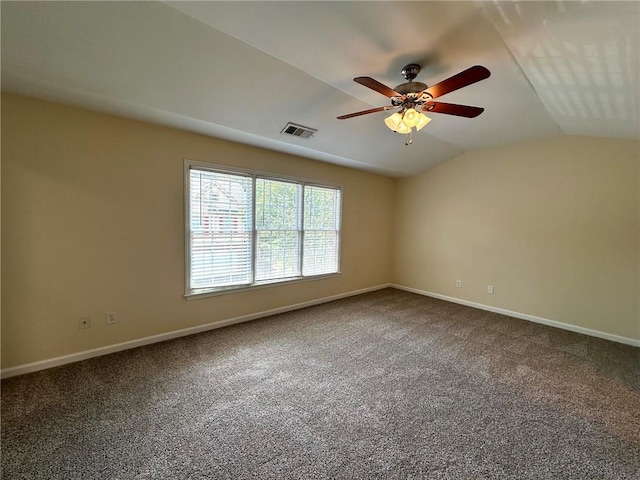 carpeted spare room featuring ceiling fan and vaulted ceiling