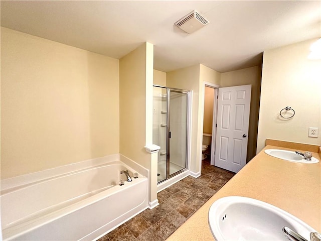 full bathroom featuring independent shower and bath, sink, and toilet