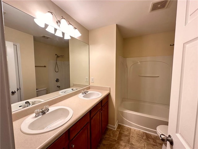 full bathroom with bathing tub / shower combination, vanity, and toilet