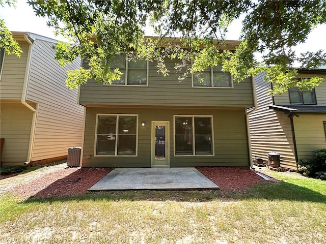 rear view of property with a patio and a lawn