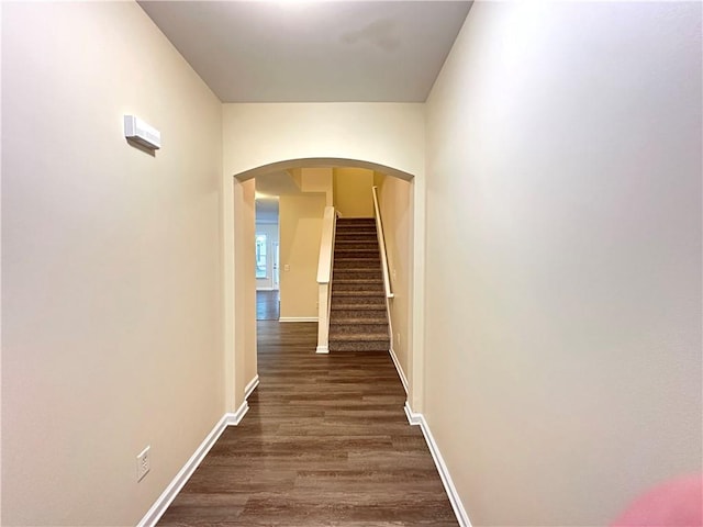 hallway with dark hardwood / wood-style flooring