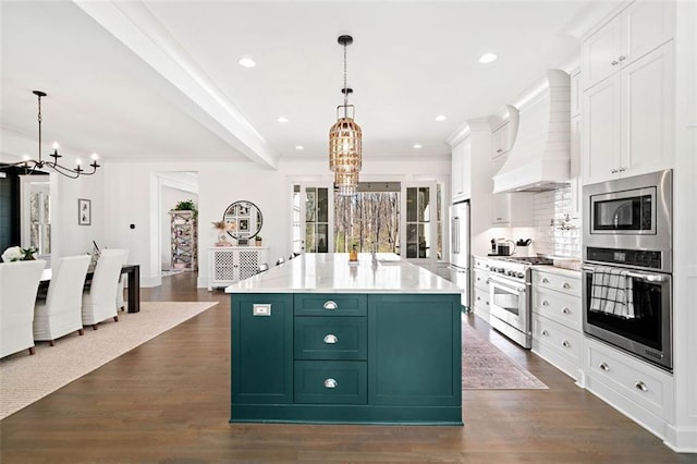 kitchen featuring premium appliances, a chandelier, white cabinetry, custom range hood, and green cabinetry