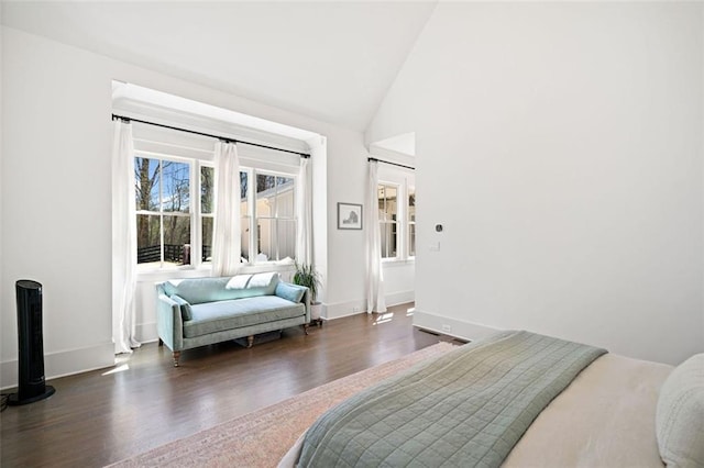 bedroom featuring high vaulted ceiling, baseboards, and wood finished floors