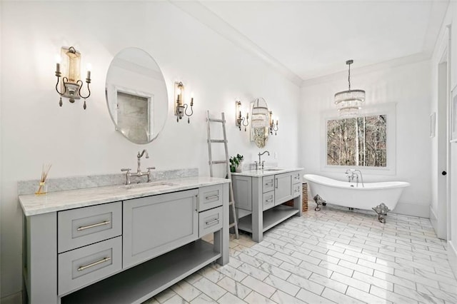 full bath featuring two vanities, a soaking tub, a sink, and a notable chandelier