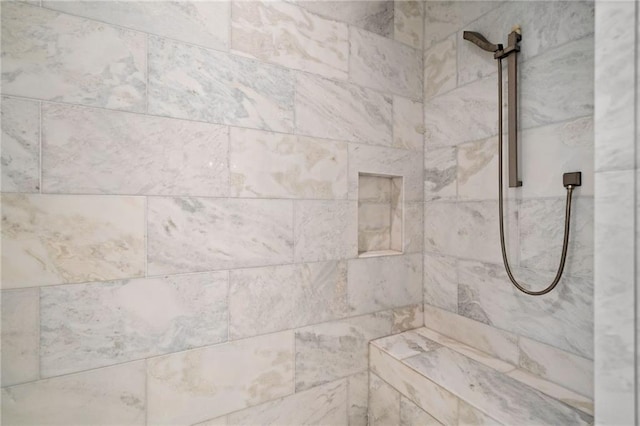 interior details with a tile shower
