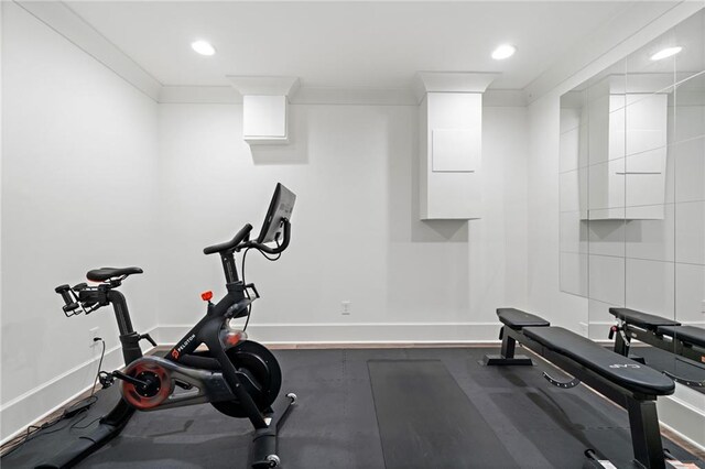 exercise area featuring recessed lighting, a wall mounted air conditioner, baseboards, and wood finished floors