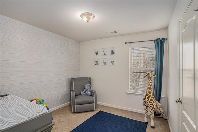 bedroom with carpet floors, wood walls, baseboards, and visible vents