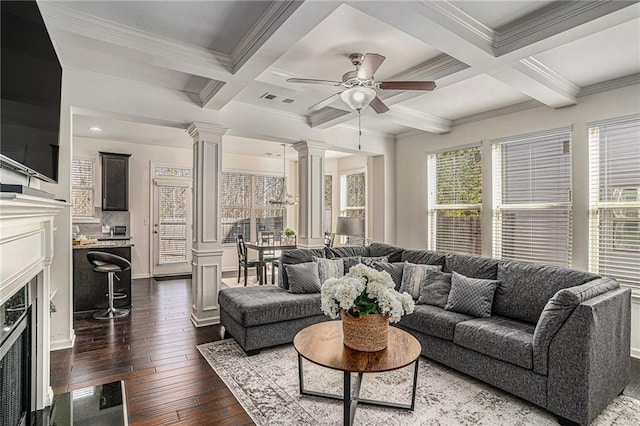 living area with visible vents, coffered ceiling, dark wood-style floors, ornate columns, and a fireplace