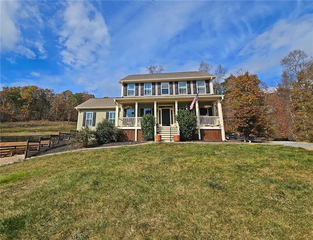 colonial house featuring covered porch and a front lawn